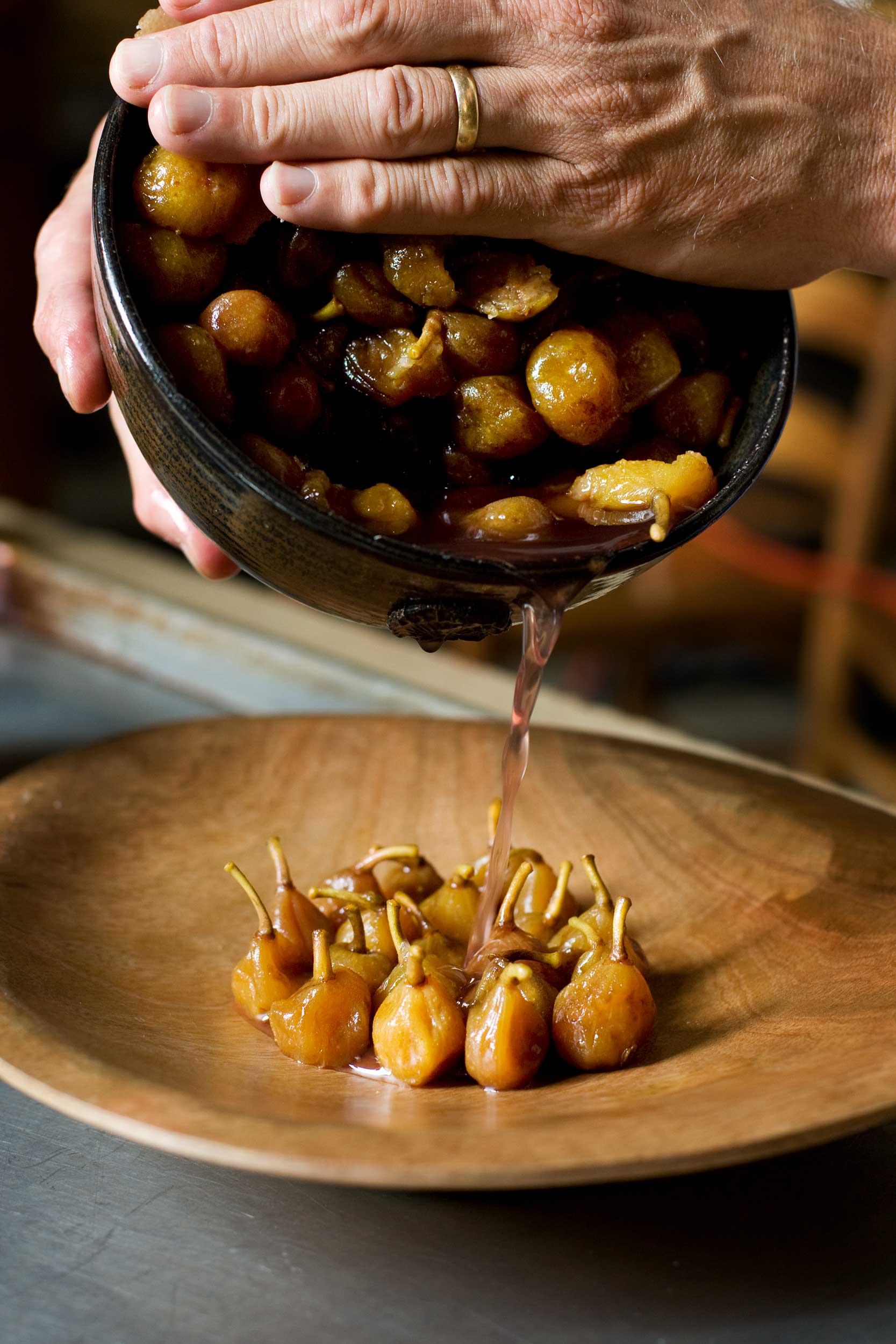 vertical-shot-of-Chris-pouring-liquid-over-preserved-figs
